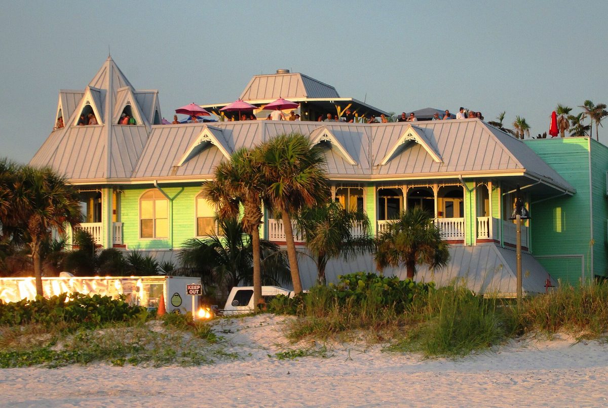 Colorful waterfront seafood restaurant with palm trees on the Gulf Coast