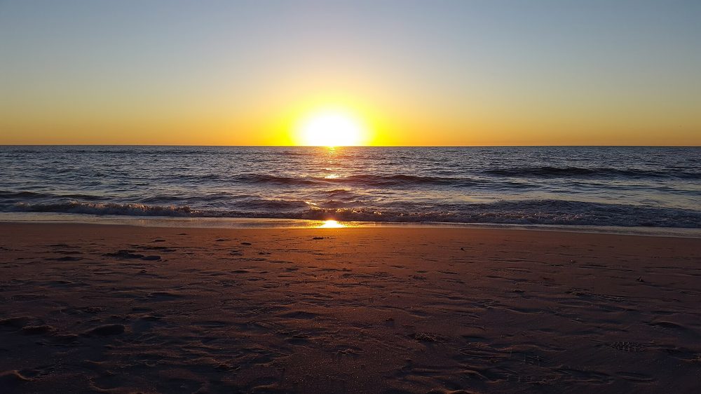 Sun setting over the Gulf at Naples Beach