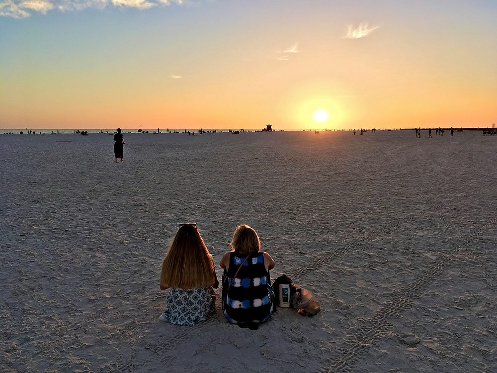 Friends watching the sunset on Siesta Beach, Sarasota